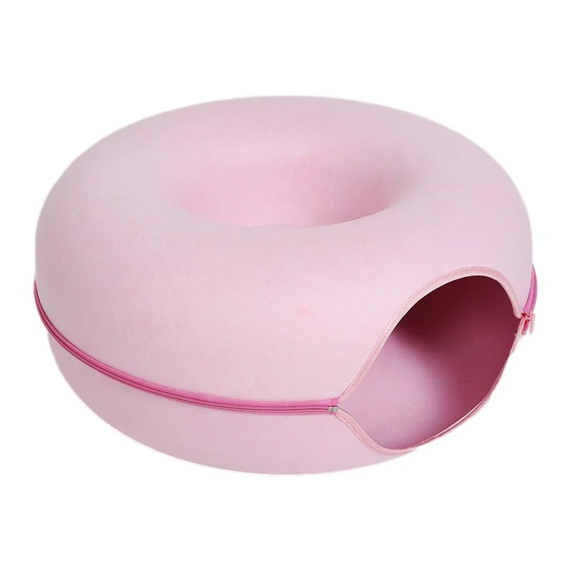 Round pink pet bed with an entrance and zippered closure.